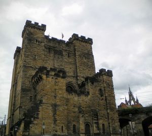 Low angle view of castle against cloudy sky