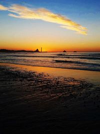 Scenic view of beach against sky during sunset