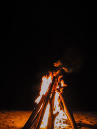 Bonfire on wooden structure at night