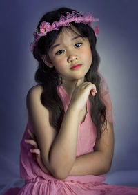 Portrait of cute girl with pink flowers