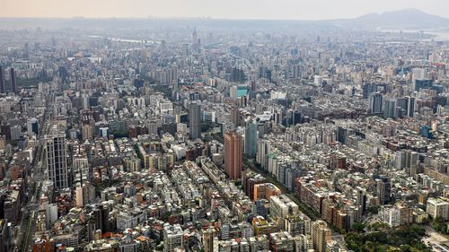 Aerial view of modern buildings in city against sky