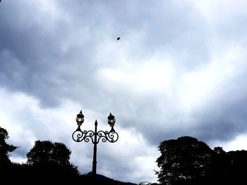 Low angle view of silhouette bird flying against sky