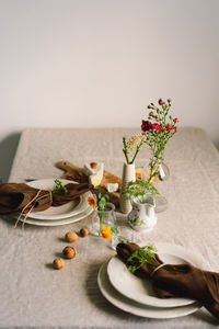 Vintage table setting with linen napkins and floral decorations. close up.