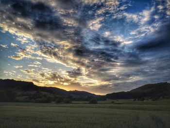 Scenic view of field against sky during sunset
