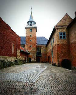 Narrow walkway leading to clock tower