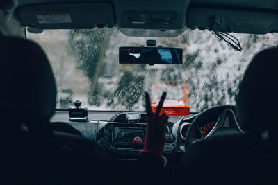 Rear view of man driving car