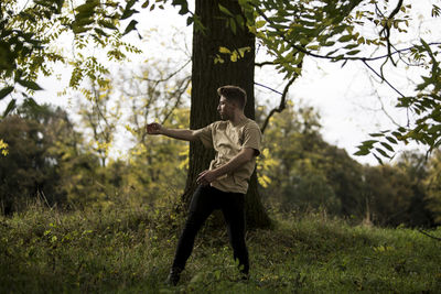 Young man dancing on grass