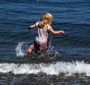 Woman jumping in sea