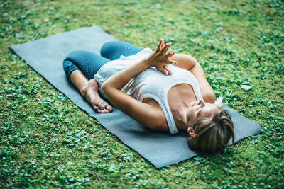High angle view of woman practicing yoga in park