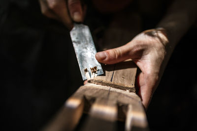 Midsection of person working on wood