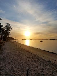 Scenic view of beach against sky during sunset