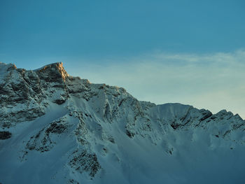 Scenic view of snowcapped mountains against clear blue sky