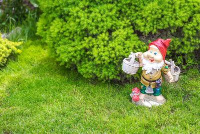 Cute boy with toy on tree