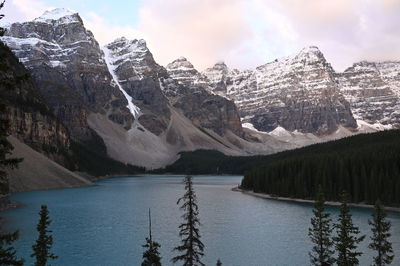 Scenic view of lake moraine by snowcapped mountains