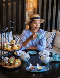 Portrait of woman sitting on table