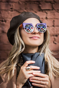 Portrait of woman holding sunglasses