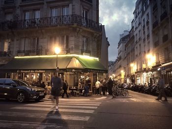 People walking on road in city at night