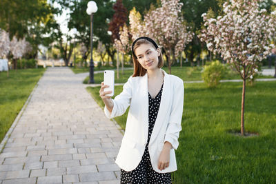 Portrait of smiling young woman standing outdoors