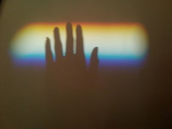 Shadow of person hand on glass