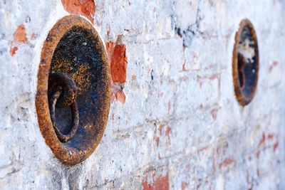 Rusty metallic mooring ring on wall