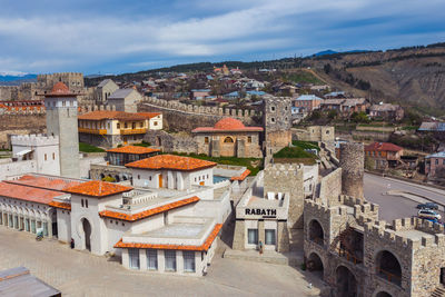 High angle view of buildings in town against sky