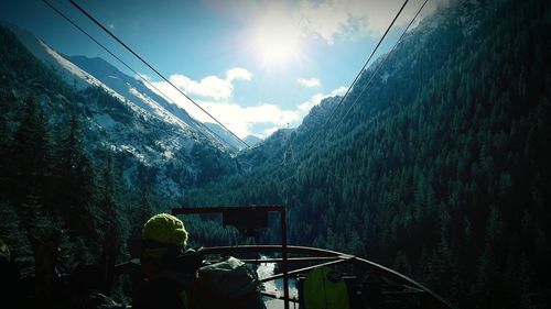 Person in boat on lake against mountains