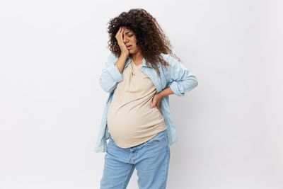 Young woman standing against white background