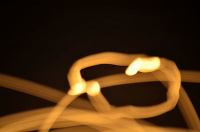 Close-up of illuminated lamp at night