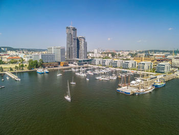 High angle view of city by sea against sky