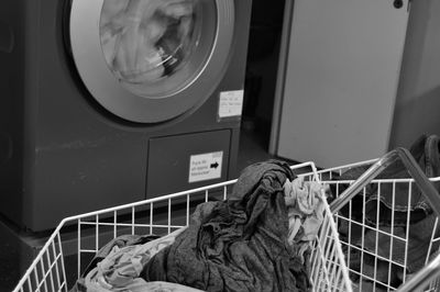 Close-up of laundry in basket against washing machine