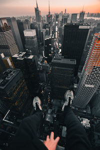 Low angle view of man photographing cityscape