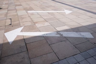 High angle view of arrow symbol on road