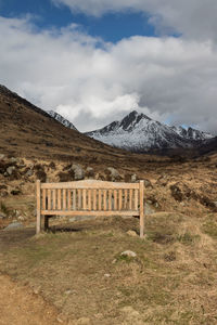 Built structure on snowcapped mountain against cloudy sky