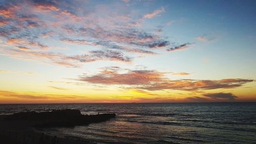 Scenic view of sea against sky at sunset