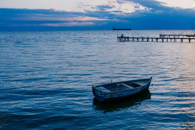 Boat moored in sea against sky