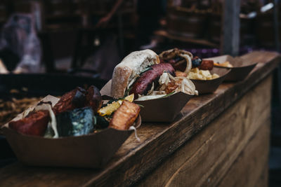 Close-up of food served in bowls on wooden table