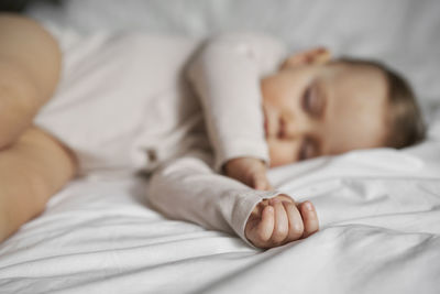 High angle view of baby sleeping on bed at home