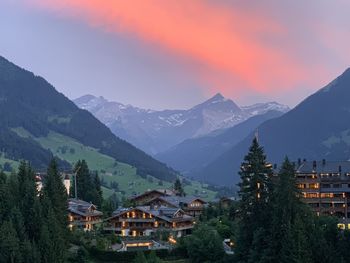 Houses and mountains against sky during sunset