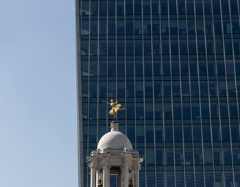 Low angle view of statue of building against clear sky