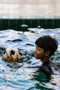 Portrait of boy swimming in pool