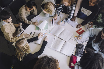 High angle view of pupils preparing for exam in classroom