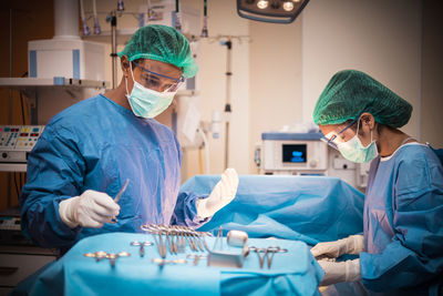 Surgeons performing operation on patient at hospital