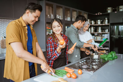 Male friends preparing food at home