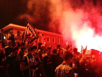 People enjoying music concert at night