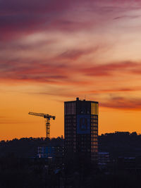 The sun sets to a stunning orange afterglow, casting an ethereal glow on the gothenburg skyline. 