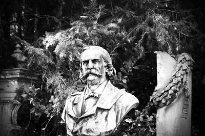 Statue against trees and plants