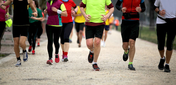 Low section of people running on road