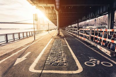 Empty road with bridge in background