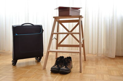 Suitcase and walking shoes in room
