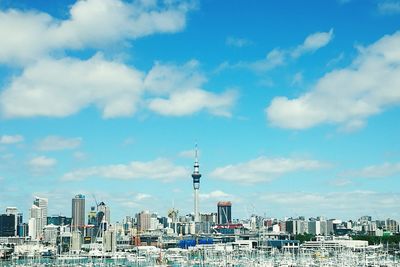 View of cityscape against cloudy sky